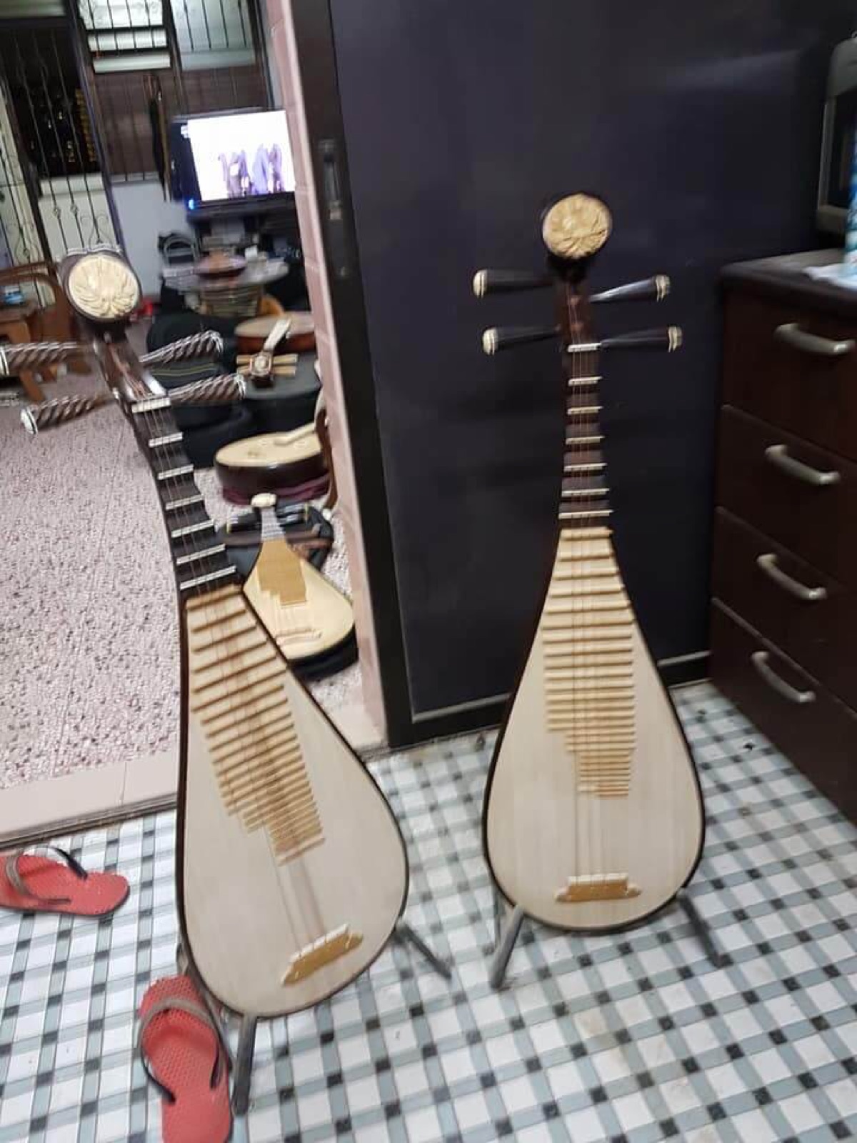 Two pipa instruments on stands