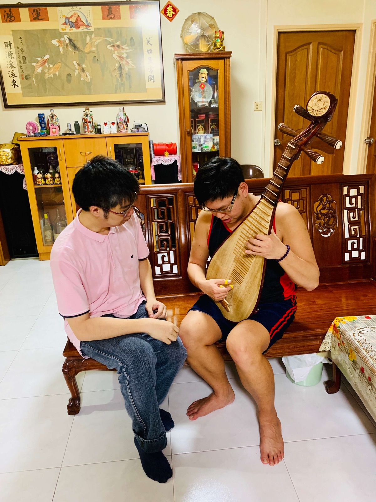 Adult learner receiving a private pipa lesson at home in Singapore